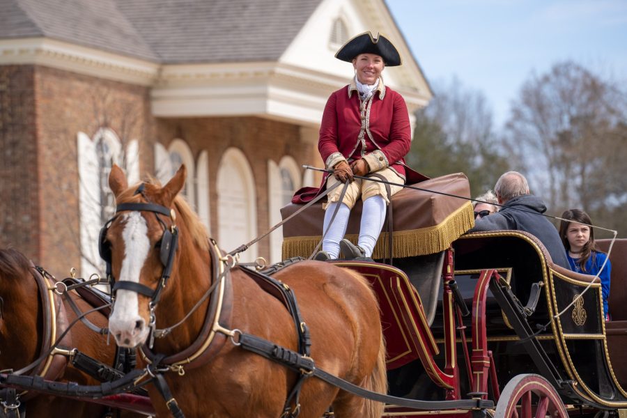 A colonial themed carriage driver smiles on a cool Spring day. A colonial themed carriage driver smiles on a cool Spring day.